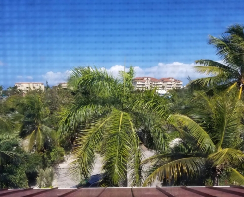 View from top floor bedroom to Grace Bay Club and beach | French Riviera (2nd floor condo)